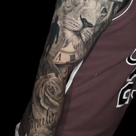 Realistic lion and roses full sleeve tattoo in black and grey realism, done at Blesink Tattoo Porto